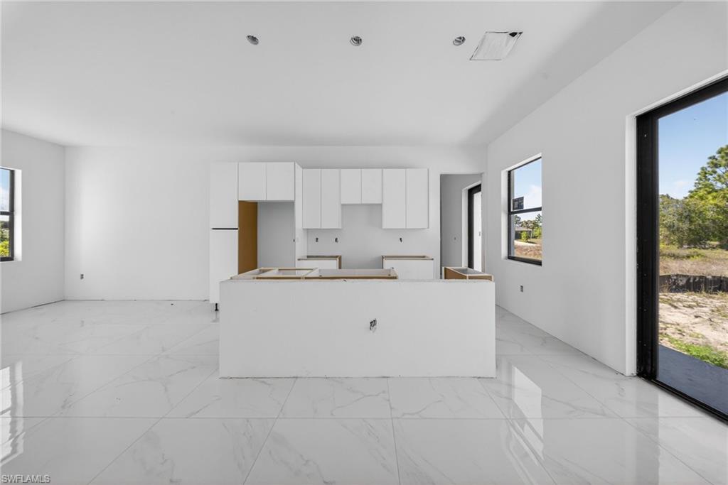 1213 Dodwin Street East Lehigh Acres, FL 33974 - Photo 7 of 28 a view of kitchen with white cabinets