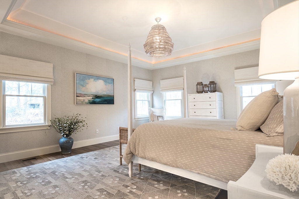 5 Pasture Road Bourne, MA 02534 - Photo 15 of 37 a bedroom with a bed and a chandelier