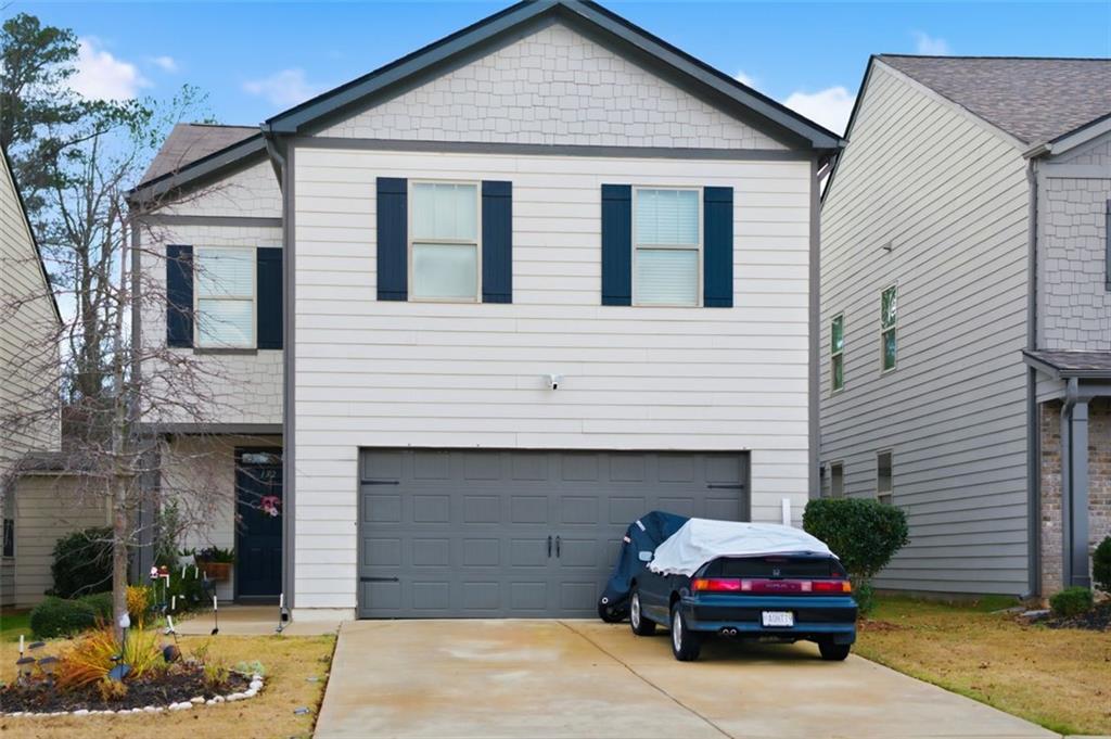 a car parked in front of white house