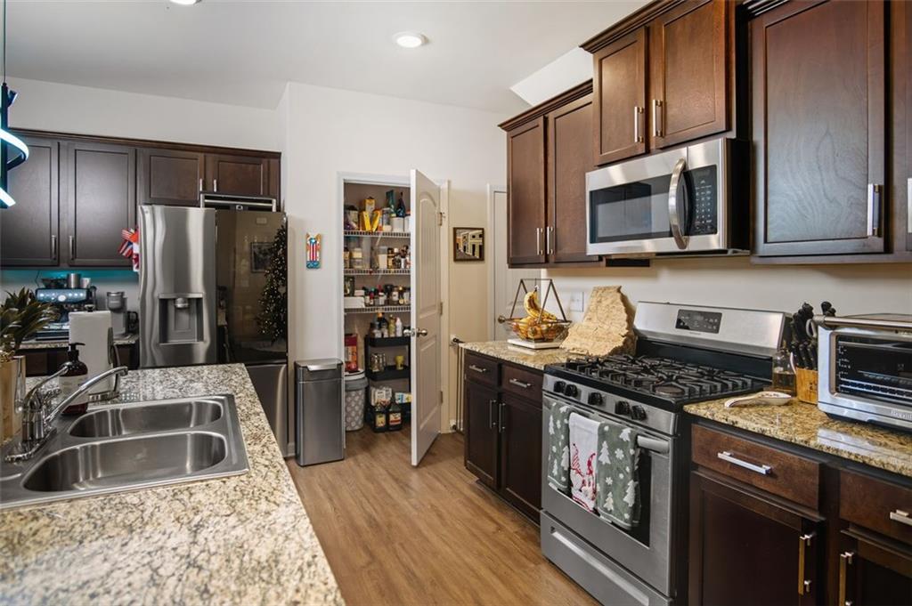 132 Centennial Ridge Drive Acworth, GA 30102 - Photo 12 of 38 a kitchen with stainless steel appliances granite countertop a stove refrigerator and microwave