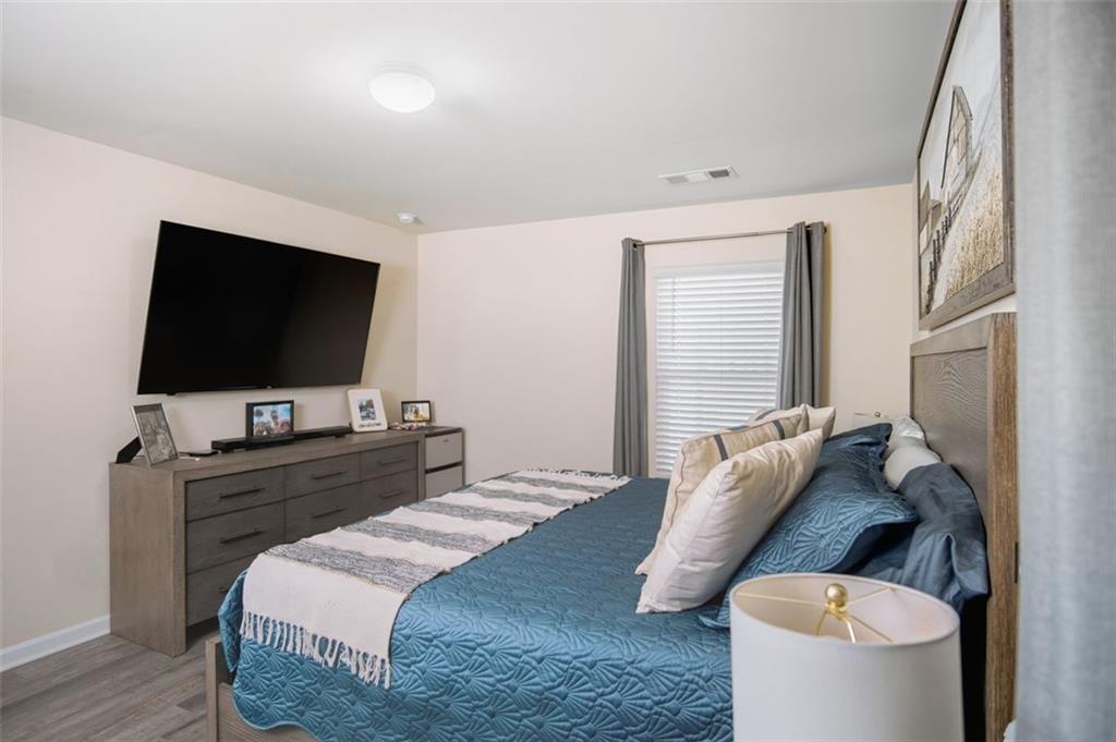 132 Centennial Ridge Drive Acworth, GA 30102 - Photo 26 of 38 a bedroom with a bed and a flat screen tv