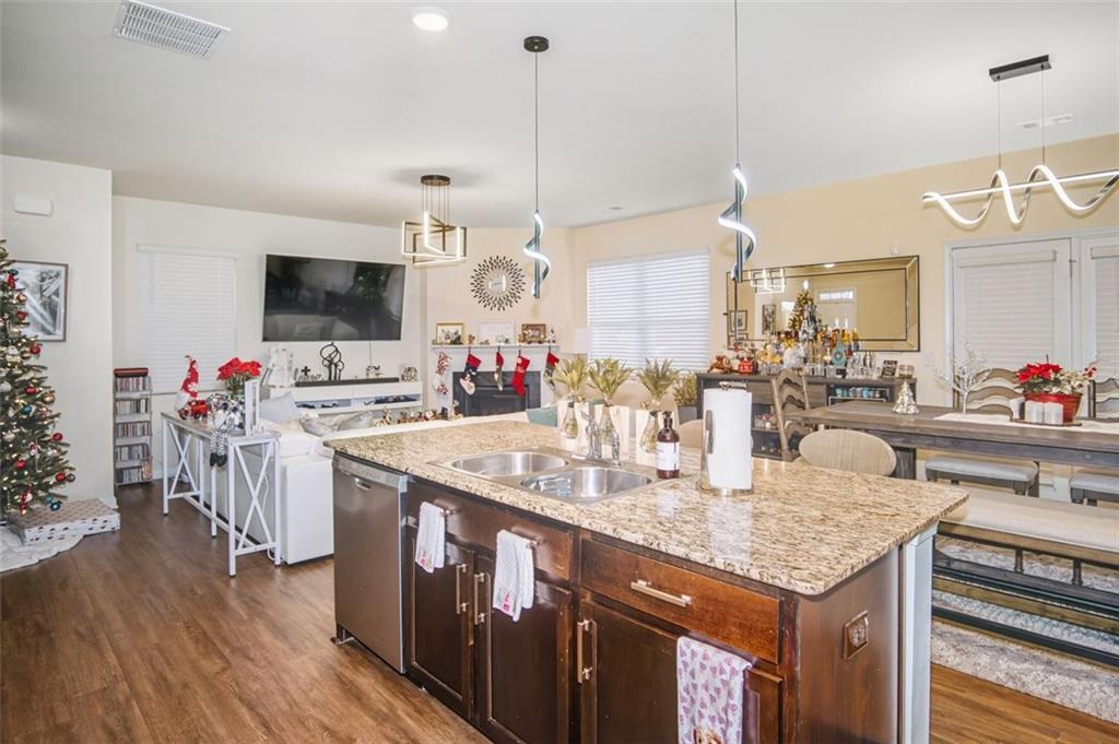 132 Centennial Ridge Drive Acworth, GA 30102 - Photo 9 of 38 a kitchen with granite countertop a sink cabinets and wooden floor