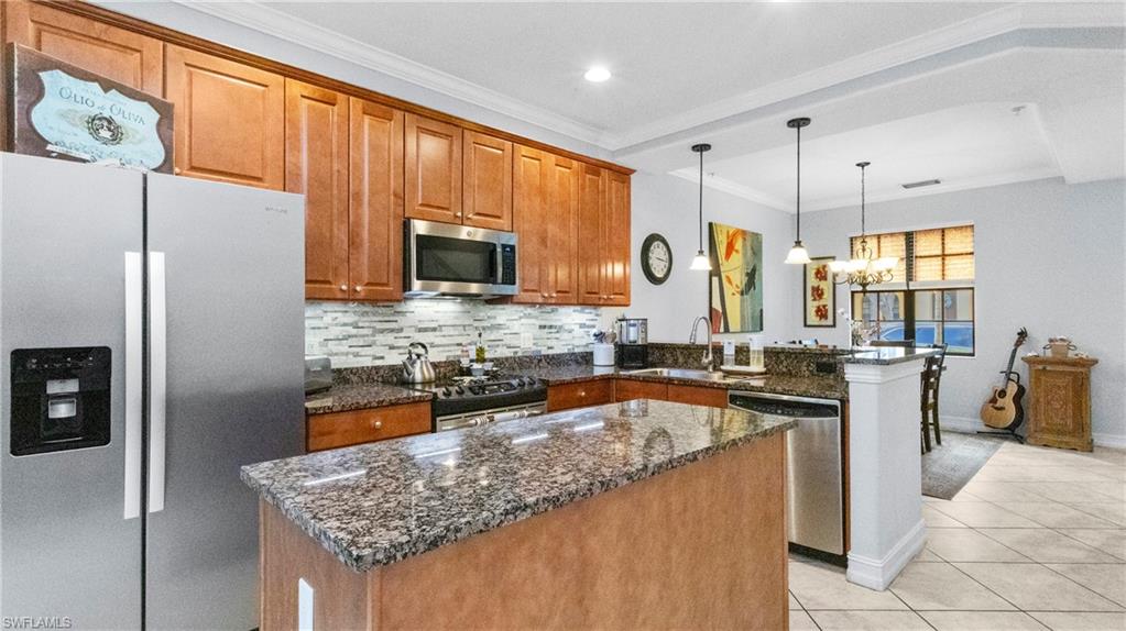 9080 Chula Vista Street, Unit 10401 Naples, FL 34113 - Photo 11 of 49 a kitchen with stainless steel appliances granite countertop a sink stove and refrigerator