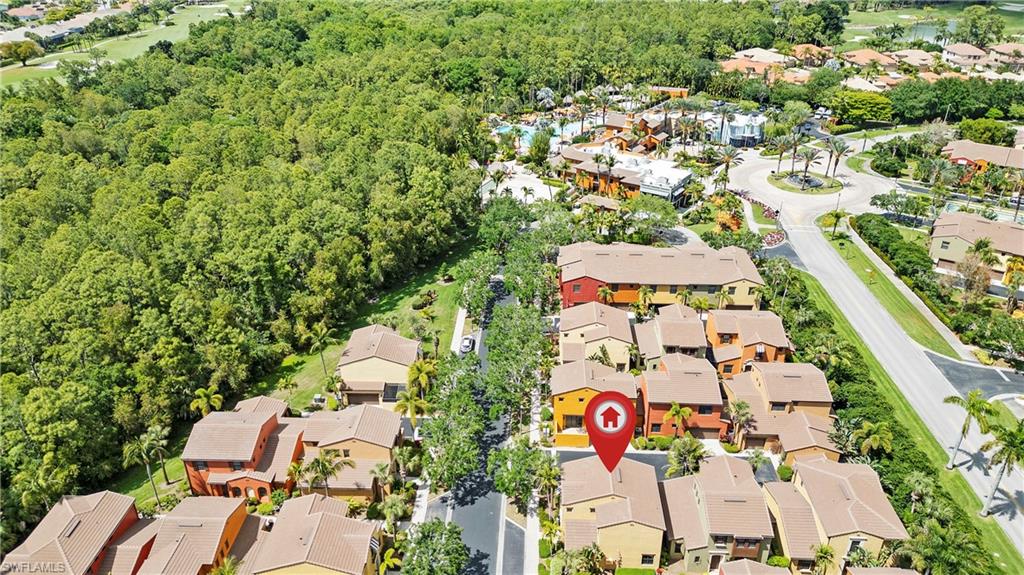 9080 Chula Vista Street, Unit 10401 Naples, FL 34113 - Photo 2 of 49 an aerial view of residential house with outdoor space and parking