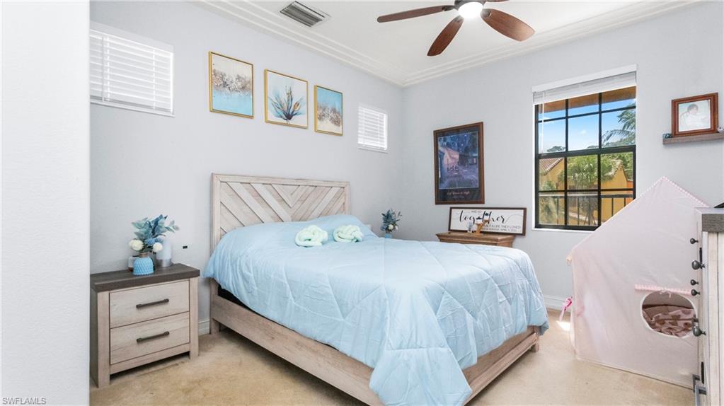 9080 Chula Vista Street, Unit 10401 Naples, FL 34113 - Photo 22 of 49 a bedroom with a bed and window