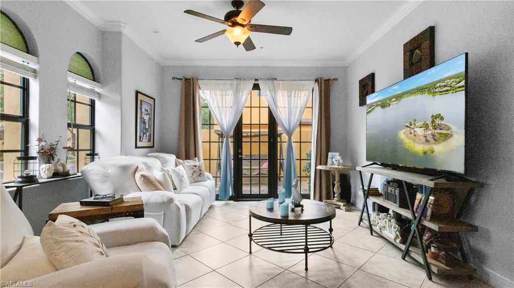 9080 Chula Vista Street, Unit 10401 Naples, FL 34113 - Photo 3 of 49 a living room with fireplace furniture and a flat screen tv