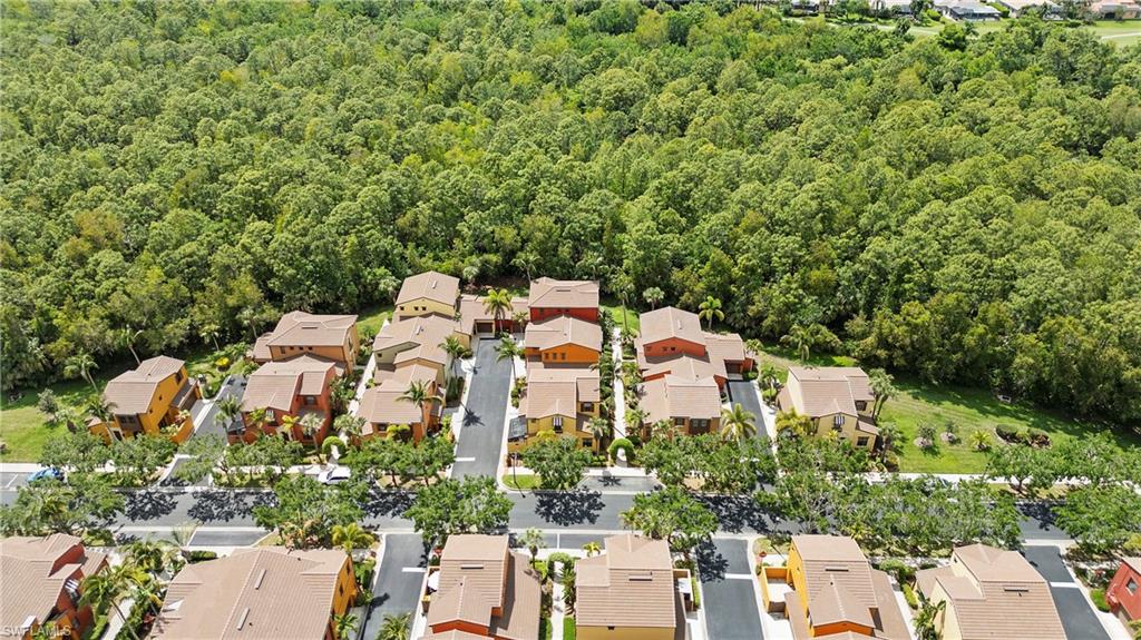 9080 Chula Vista Street, Unit 10401 Naples, FL 34113 - Photo 33 of 49 an aerial view of a house with a yard and parking spaces