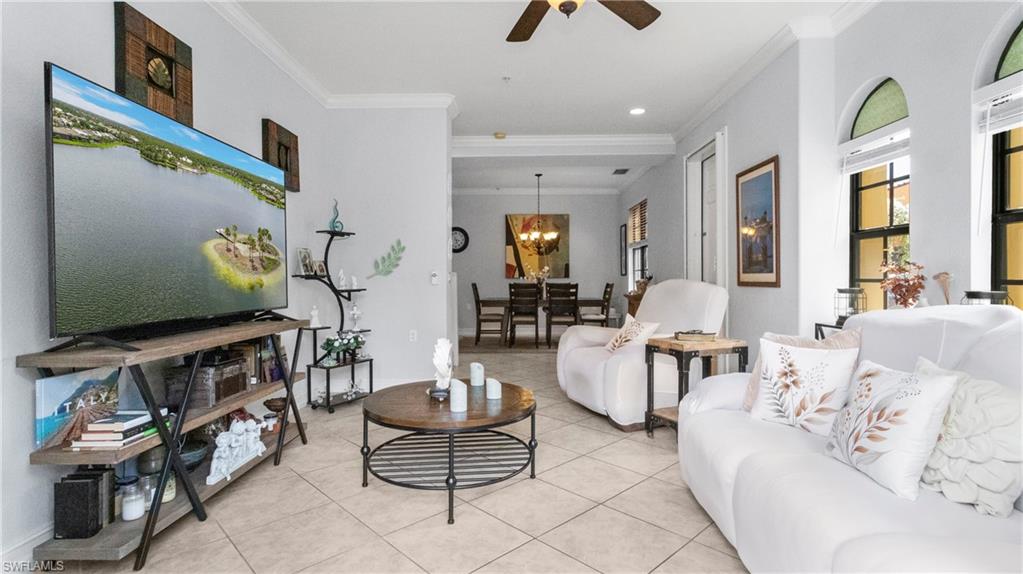 9080 Chula Vista Street, Unit 10401 Naples, FL 34113 - Photo 5 of 49 a living room with furniture and a flat screen tv