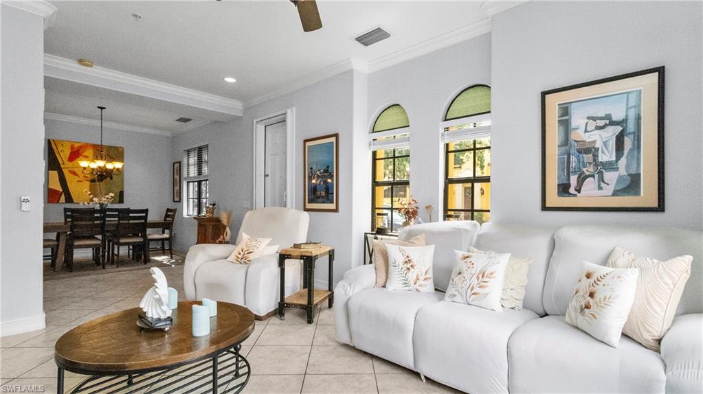 9080 Chula Vista Street, Unit 10401 Naples, FL 34113 - Photo 6 of 49 a living room with furniture and a chandelier
