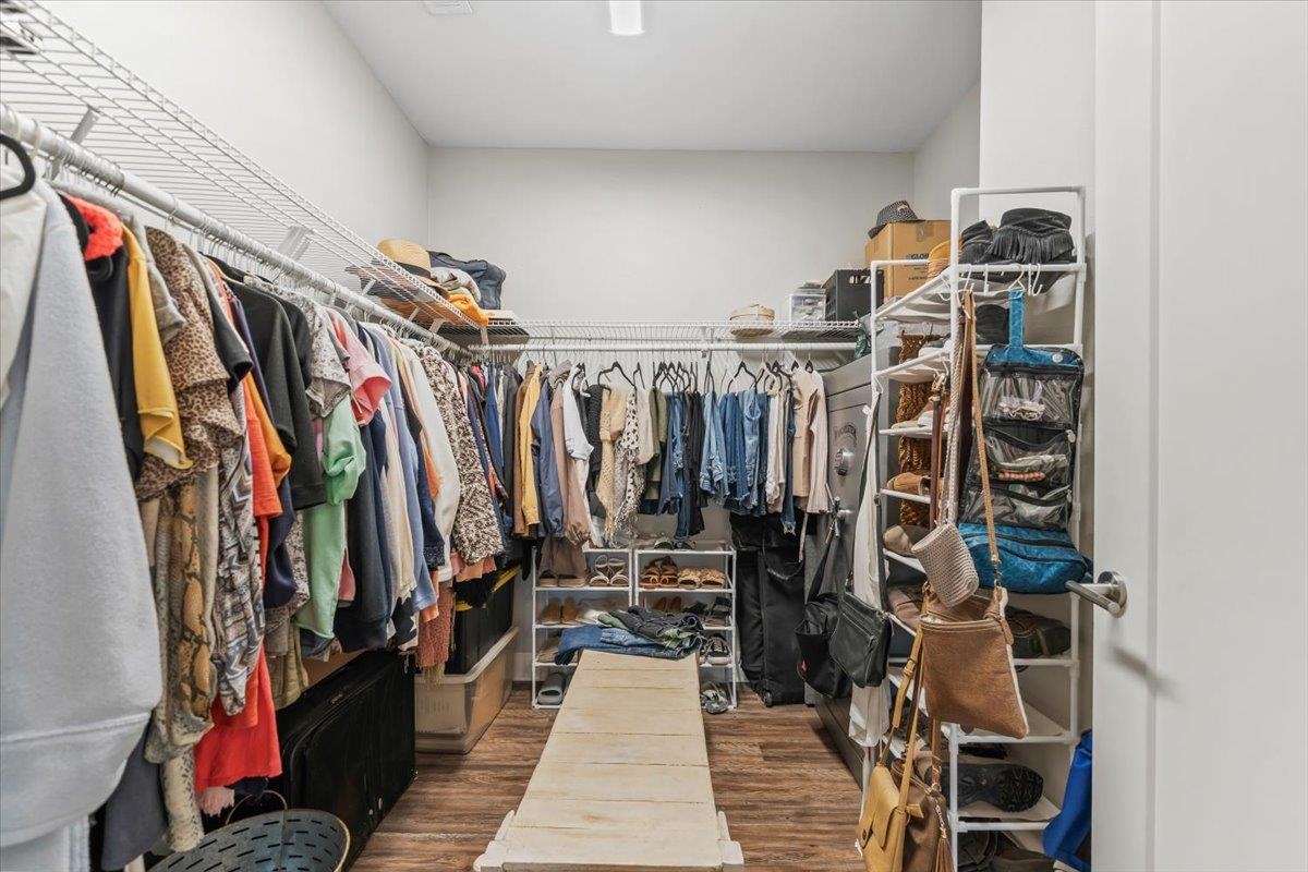 415 Abbey Road, Unit D Munford, TN 38058 - Photo 21 of 35 Spacious walk-in closet featuring wood-finish flooring, white walls, and extensive wire shelving with hanging rods