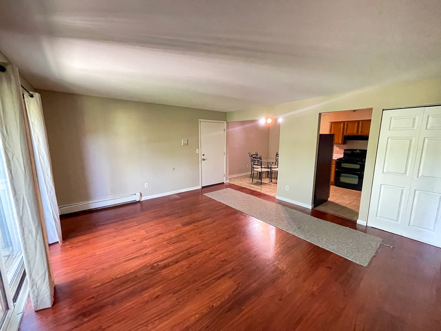 19360 Wolf Road, Unit 8 Mokena, IL 60448 - Photo 5 of 23 an empty room with wooden floor and windows