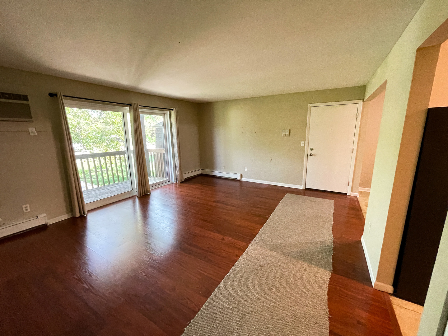 19360 Wolf Road, Unit 8 Mokena, IL 60448 - Photo 6 of 23 a view of an empty room with wooden floor and a window