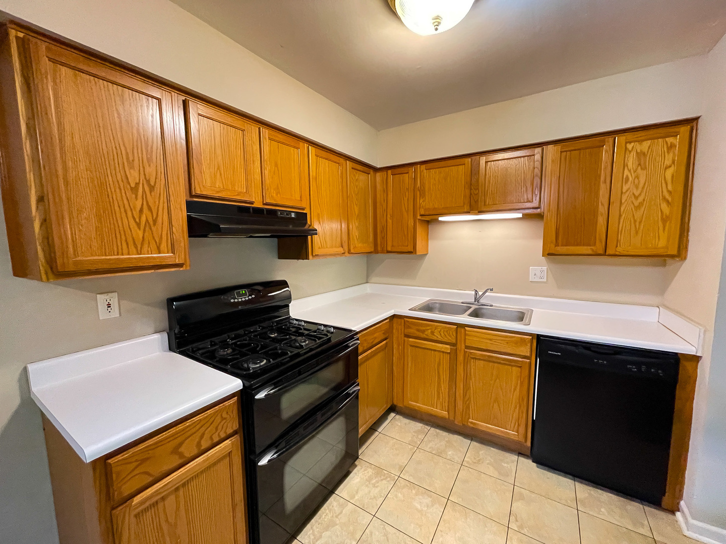 19360 Wolf Road, Unit 8 Mokena, IL 60448 - Photo 9 of 23 a kitchen with a sink a stove cabinets and a window