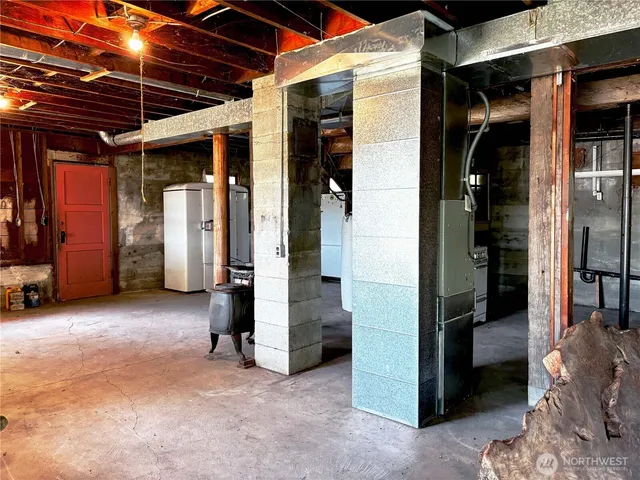 a view of a kitchen with stainless steel appliances wooden floor and a living room