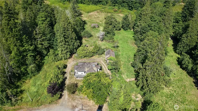 an aerial view of a house with a yard