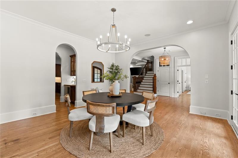 4290 Bobbins Way Cumming, GA 30041 - Photo 21 of 133 a view of a dining room with furniture a chandelier and wooden floor
