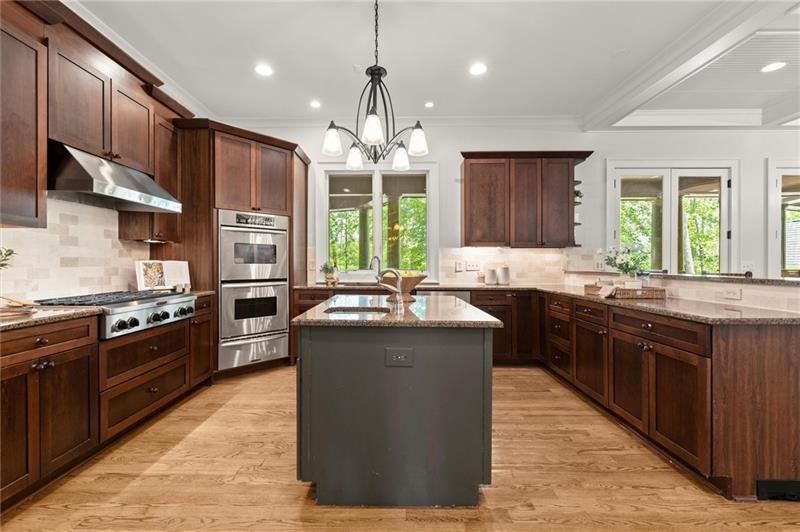 4290 Bobbins Way Cumming, GA 30041 - Photo 28 of 133 a kitchen with stainless steel appliances granite countertop wooden cabinets a sink dishwasher a stove and a refrigerator