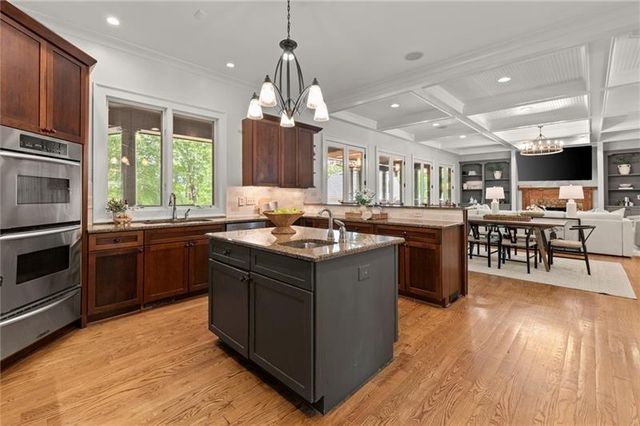 a bathroom with a granite countertop sink a toilet and shower