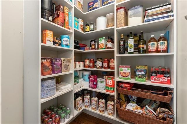 an empty room with wooden floor and window