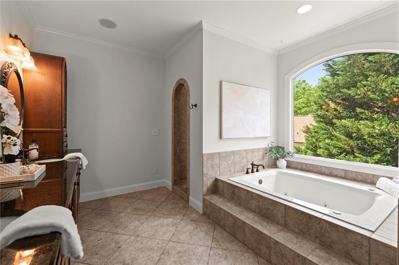 4290 Bobbins Way Cumming, GA 30041 - Photo 55 of 133 a bathroom with a tub a sink and a window
