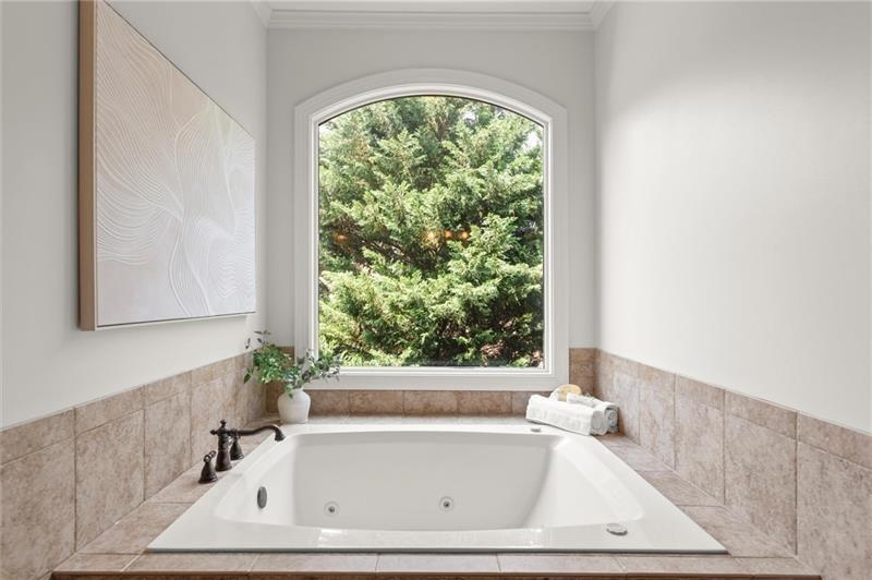 4290 Bobbins Way Cumming, GA 30041 - Photo 57 of 133 a bath tub sitting in a bathroom next to a window