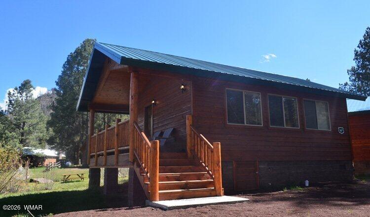 97 Rohrer Road Greer, AZ 85927 - Photo 2 of 14 a front view of house with stairs