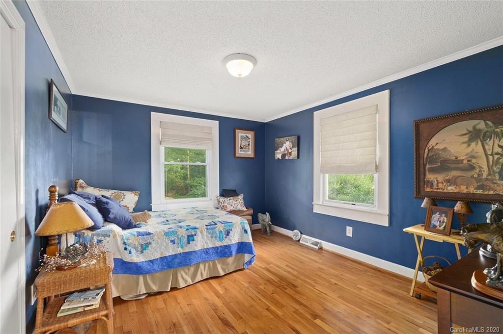 185 Hunter Bridge Road Stony Point, NC 28678 - Photo 14 of 47 a bedroom with a bed and wooden floor