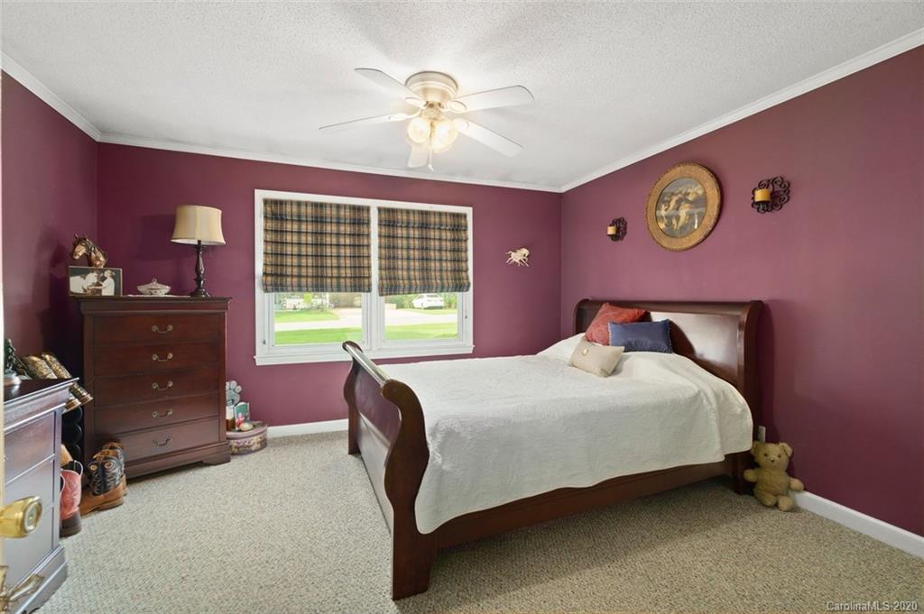 185 Hunter Bridge Road Stony Point, NC 28678 - Photo 17 of 47 a bedroom with a bed and a table with chair