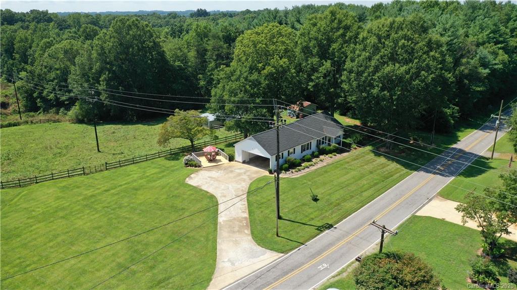 185 Hunter Bridge Road Stony Point, NC 28678 - Photo 36 of 47 a view of a tennis ground with large trees