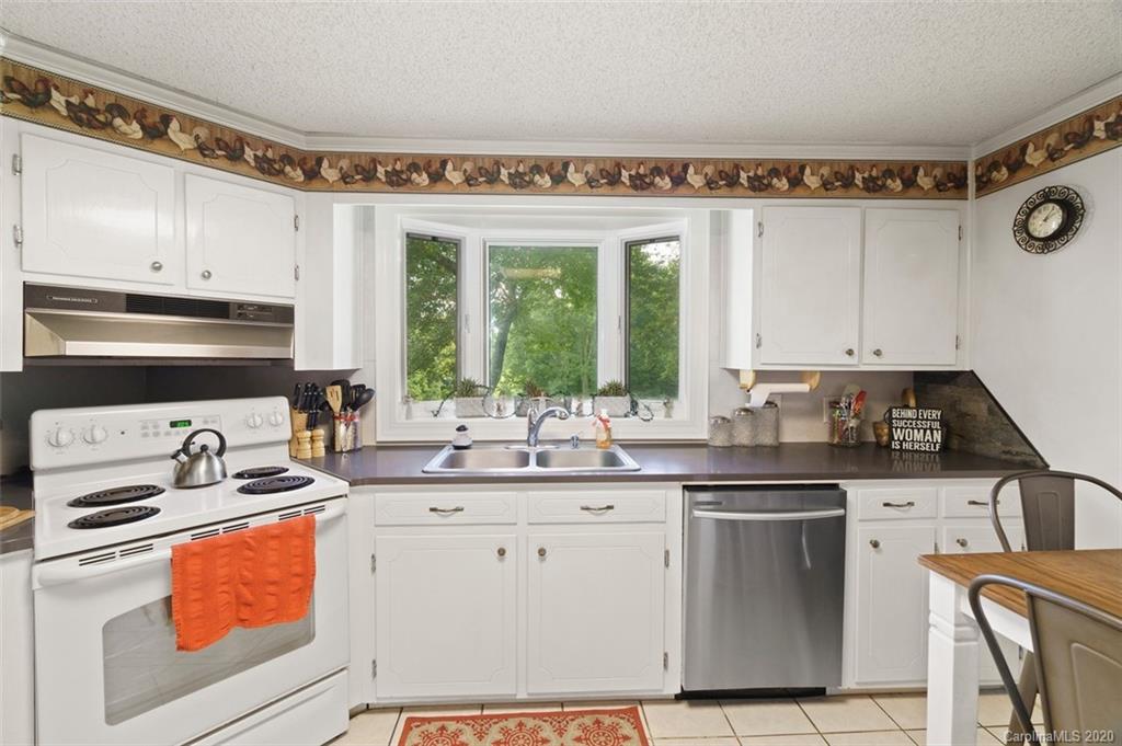 185 Hunter Bridge Road Stony Point, NC 28678 - Photo 7 of 47 a kitchen with stainless steel appliances granite countertop a sink stove and cabinets