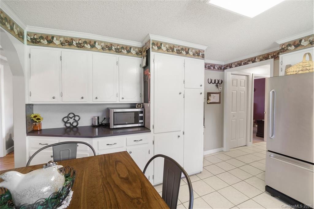 185 Hunter Bridge Road Stony Point, NC 28678 - Photo 10 of 47 a kitchen with stainless steel appliances a refrigerator sink and cabinets