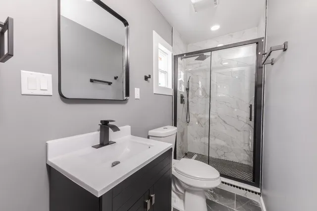 a bathroom with a toilet sink and shower