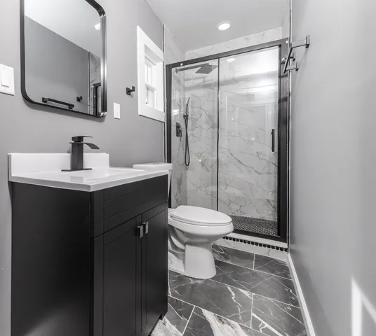 a bathroom with a sink toilet and shower