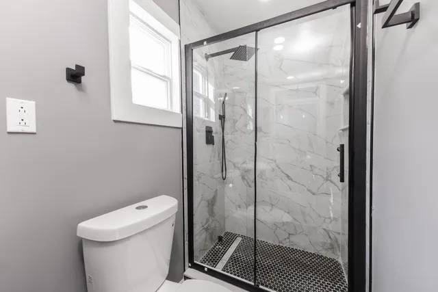 a bathroom with a shower and toilet