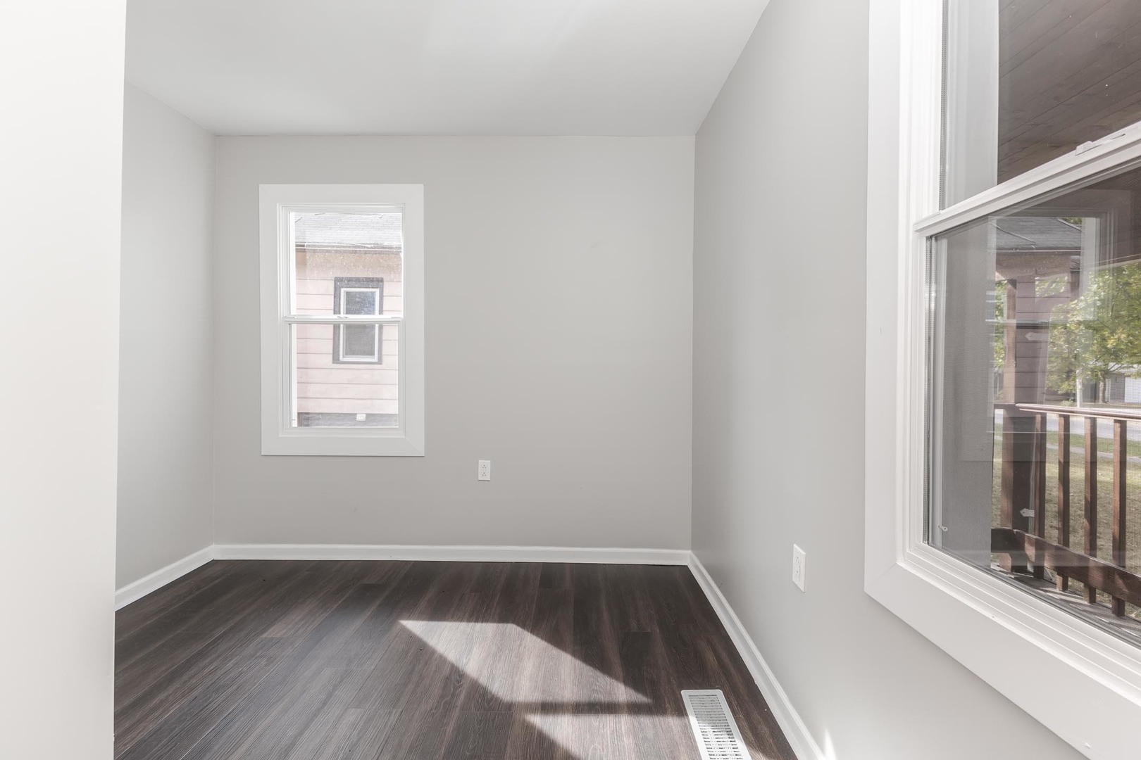 306 East Martin Street Forrest, IL 61741 - Photo 19 of 32 an empty room with wooden floor and windows