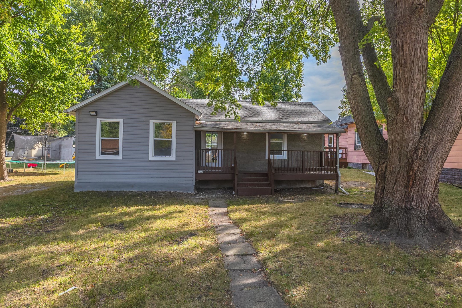 306 East Martin Street Forrest, IL 61741 - Photo 2 of 32 a view of a house with a large tree and a yard