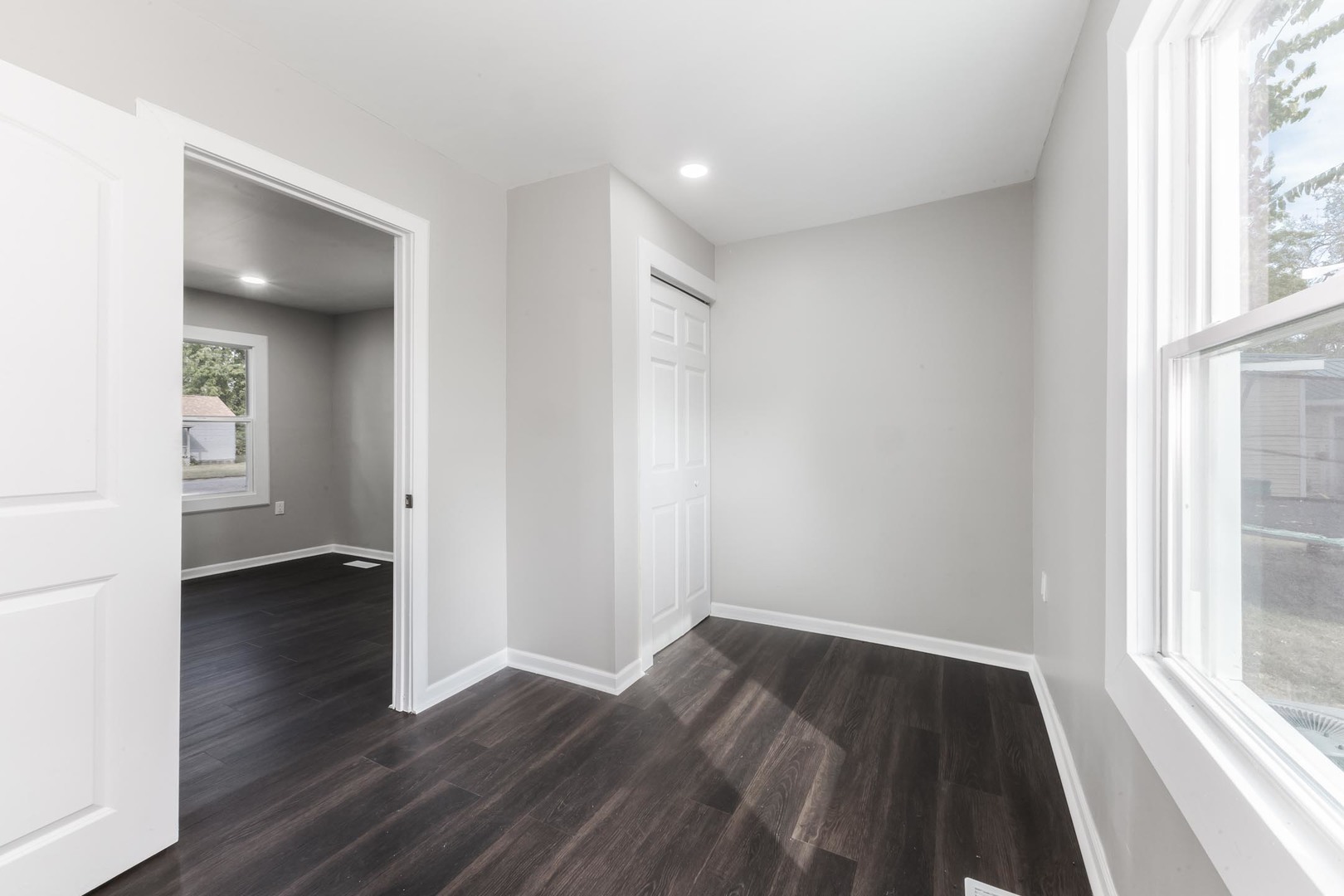 306 East Martin Street Forrest, IL 61741 - Photo 21 of 32 an empty room with wooden floor and windows
