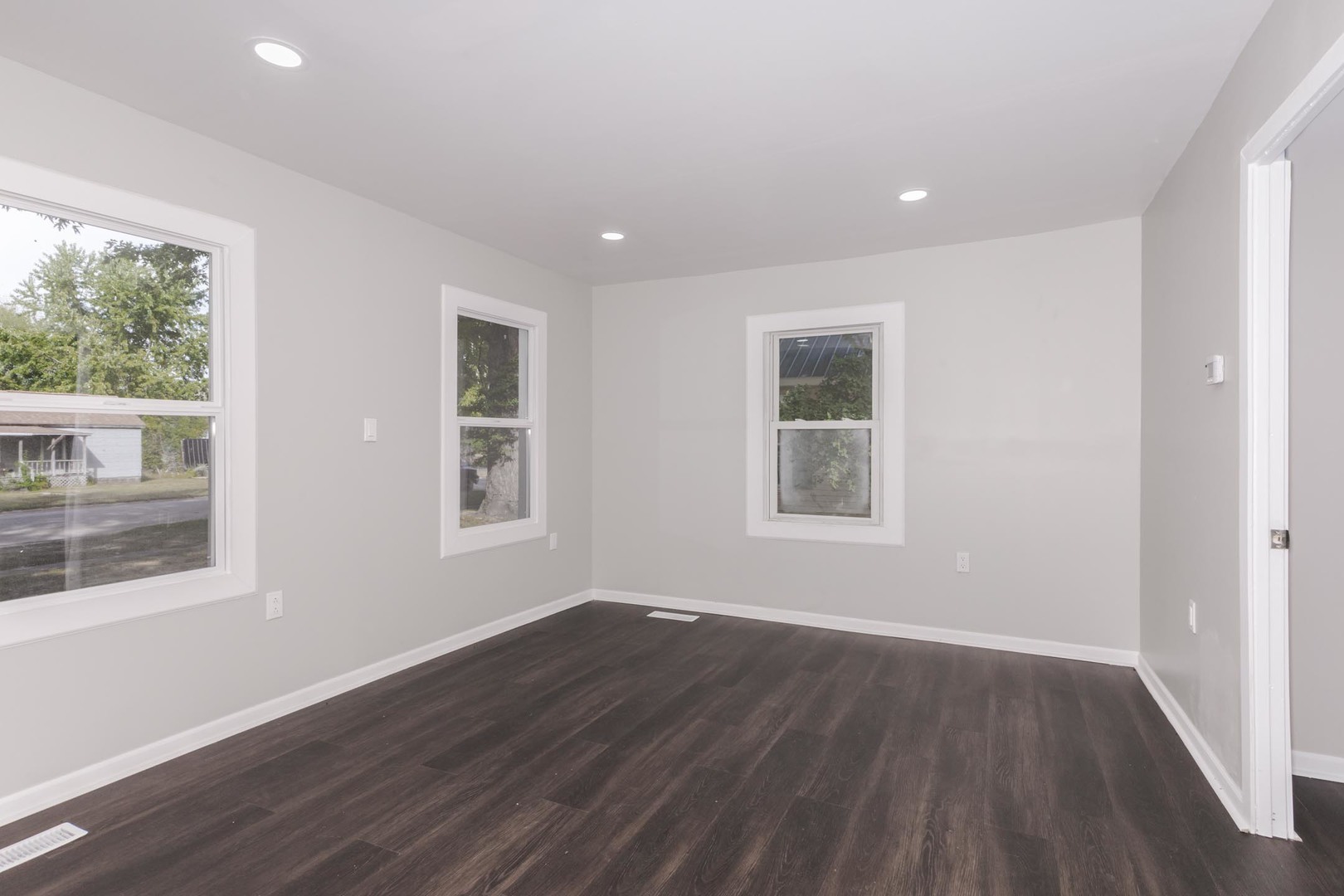 306 East Martin Street Forrest, IL 61741 - Photo 22 of 32 a view of an empty room with wooden floor and a window