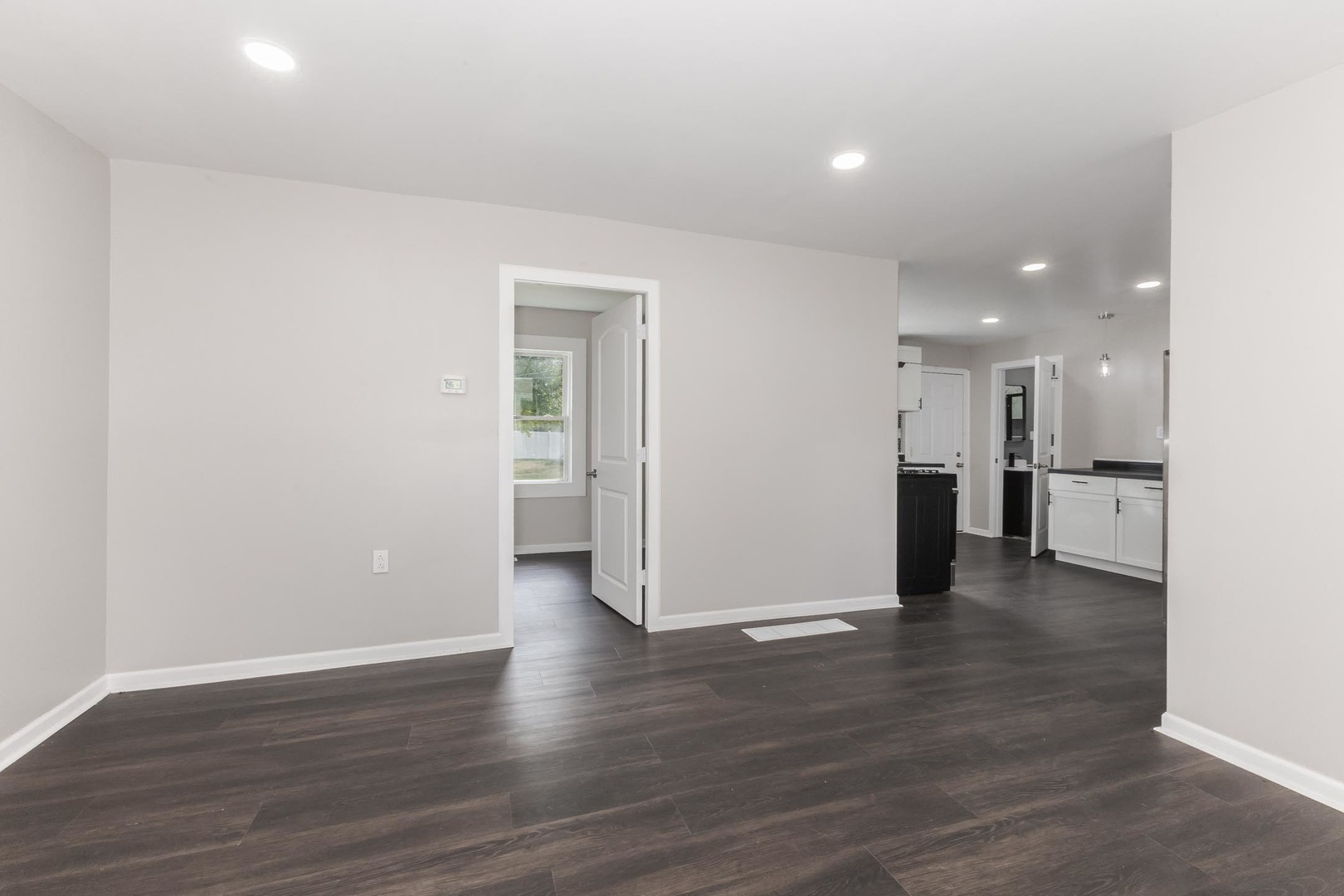 306 East Martin Street Forrest, IL 61741 - Photo 26 of 32 a view of a big room with wooden floor and a kitchen