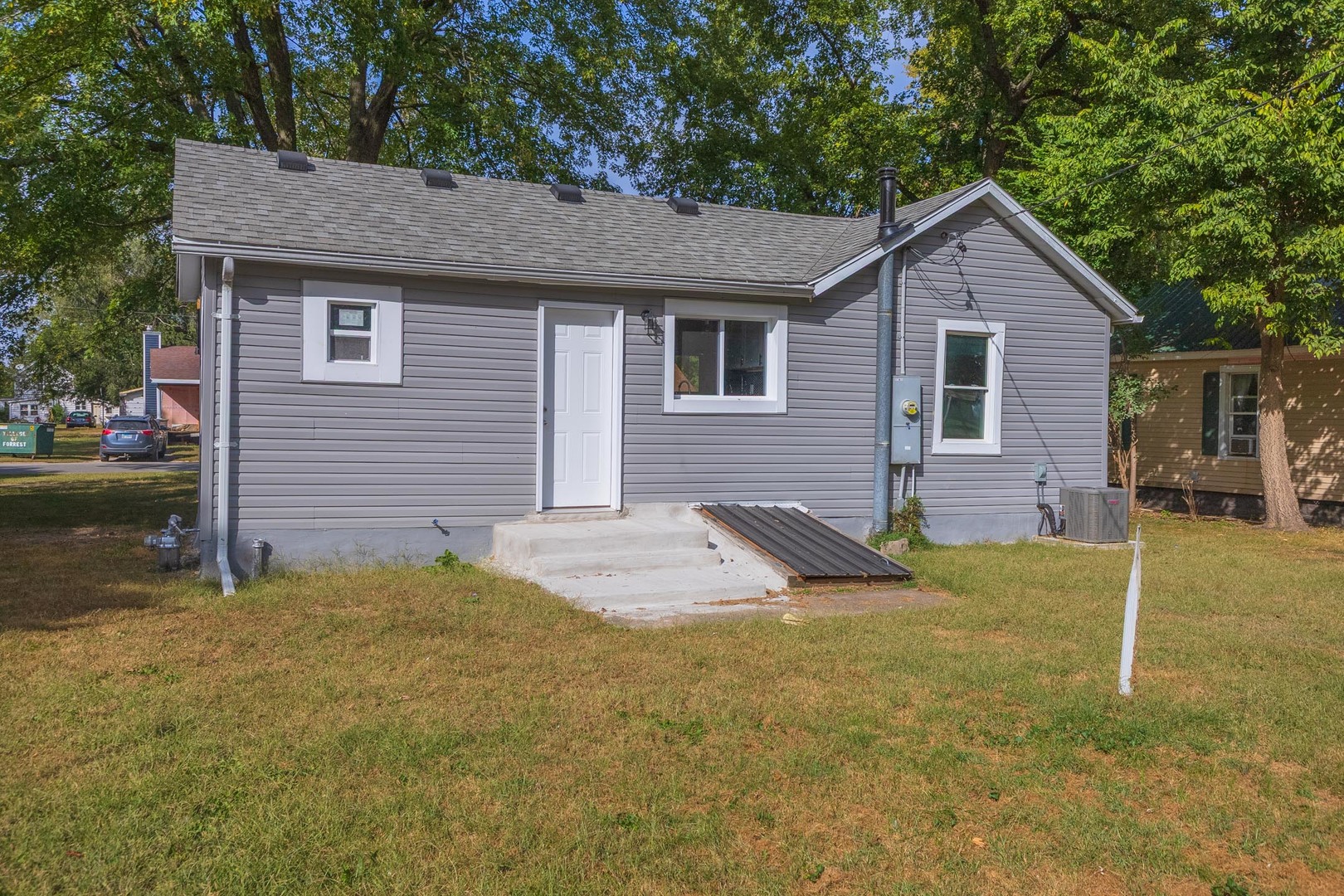 306 East Martin Street Forrest, IL 61741 - Photo 30 of 32 a view of a house with a yard and lawn chairs
