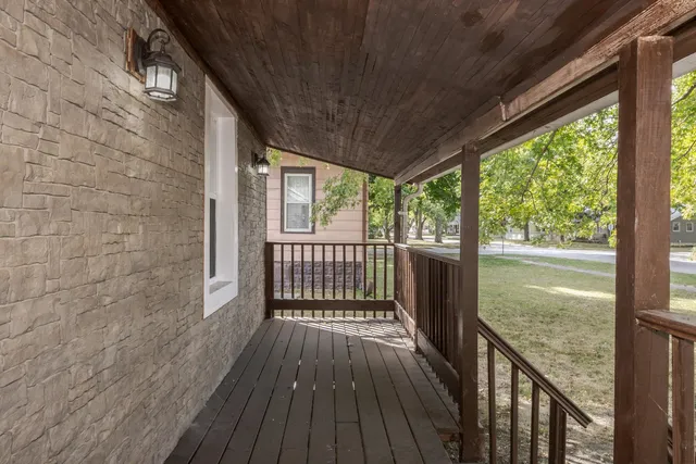 a view of a balcony with wooden floor