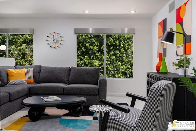 a bedroom with a bed and painting on the wall