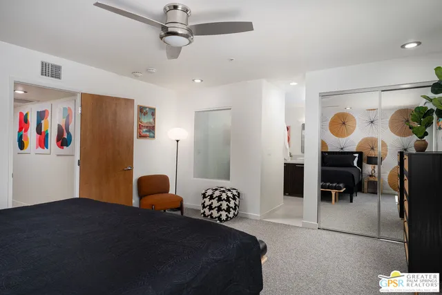 a bathroom with a granite countertop toilet sink and mirror
