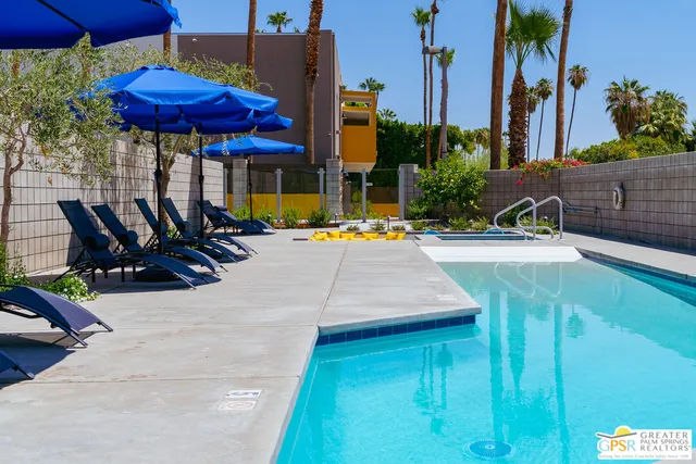 a view of tall building with large trees
