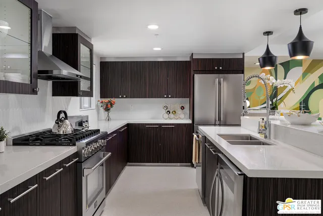 a kitchen with a dining table chairs and a room