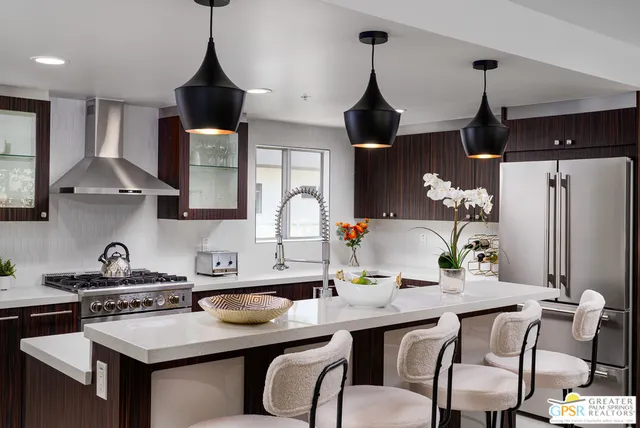 a kitchen with stainless steel appliances granite countertop a sink stove and cabinets