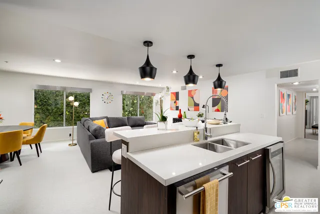 a living room with furniture and a potted plant
