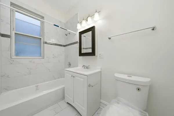 a bathroom with a sink a toilet and bathtub
