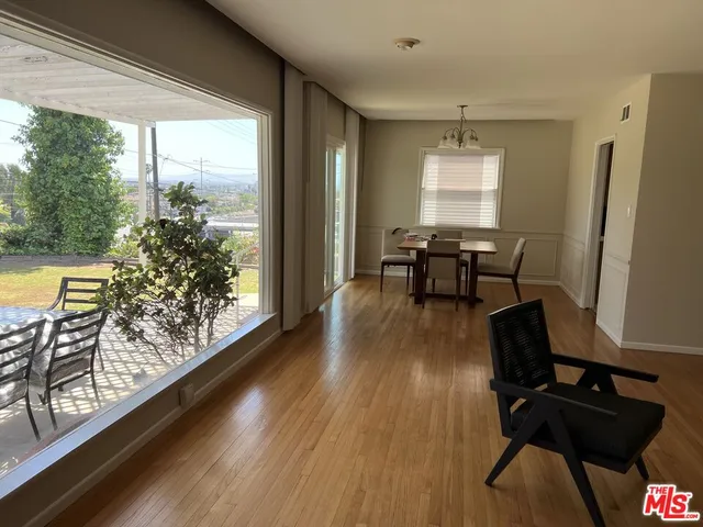 a view of a dining room with furniture window and wooden floor