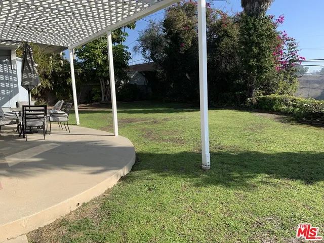 a view of a house with backyard and porch